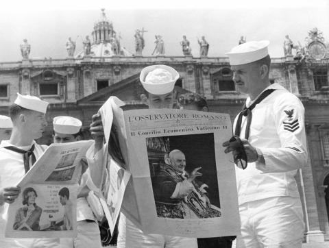 Un groupe de soldats américains lisant le journal « L'osservatore romano » en attendant des nouvelles de la santé du pape Jean XXIII sur la place Saint-Pierre le 31 mai 1963 au Vatican.